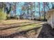 Large backyard with a sloped lawn and mature trees at 2756 Plantation Dr, East Point, GA 30344