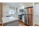 Modern kitchen featuring white cabinets, stainless steel appliances, and a kitchen island at 2756 Plantation Dr, East Point, GA 30344