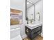 Modern bathroom with dark vanity, quartz countertop and gold fixtures at 337 Pine Ne St # B, Atlanta, GA 30308