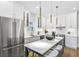 Bright kitchen featuring an island with seating, stainless steel appliances, modern white cabinets, and stylish pendant lighting at 337 Pine Ne St # B, Atlanta, GA 30308