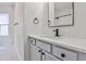 Modern bathroom with gray vanity, quartz countertop, and marble-look tile floor at 3749 Baxley Ridge Dr, Suwanee, GA 30024