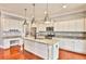 Modern kitchen with granite countertops, white cabinets and stainless steel appliances at 3749 Baxley Ridge Dr, Suwanee, GA 30024