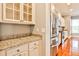 Butlers pantry with granite countertops and white cabinets at 3749 Baxley Ridge Dr, Suwanee, GA 30024