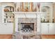 Stone fireplace with built-in shelving and a large hearth at 4802 Moon Chase Dr, Buford, GA 30519