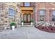 Elegant entryway with double doors, stone facade, and lush landscaping at 4802 Moon Chase Dr, Buford, GA 30519