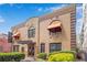 Two-story building with orange awnings and landscaping; inviting entrance at 860 Peachtree Ne St # 2513, Atlanta, GA 30308