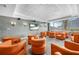 Relaxing community room with orange seating and a large TV at 860 Peachtree Ne St # 2513, Atlanta, GA 30308
