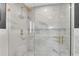 Walk-in shower with marble tile and gold fixtures at 860 Peachtree Ne St # 2513, Atlanta, GA 30308