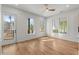 Living room with hardwood floors, ceiling fan, and multiple windows at 988 Mcdaniel Sw St, Atlanta, GA 30310