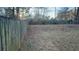 Large backyard with a wooden fence and grassy area at 2029 Downs, Lithonia, GA 30058