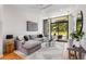 Open living space with gray sectional sofa and hardwood floors at 105 Georgia Se Ave # 2, Atlanta, GA 30312