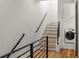 Modern stairwell with metal railing leading to upper level and laundry area at 105 Georgia Se Ave # 2, Atlanta, GA 30312