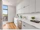Modern wet bar with white cabinets and wine cooler at 105 Georgia Se Ave # 2, Atlanta, GA 30312