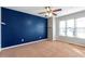 Bright bedroom with blue accent wall and ceiling fan at 320 Harden Se St, Atlanta, GA 30312