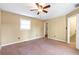 Spacious bedroom with carpet, ceiling fan, and walk-in closet at 320 Harden Se St, Atlanta, GA 30312
