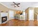 Open concept living room with hardwood floors, kitchen island, and fireplace at 320 Harden Se St, Atlanta, GA 30312