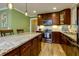 Gourmet kitchen with granite island, stainless steel appliances, and custom cabinetry at 3875 Shiloh Trail West Nw, Kennesaw, GA 30144