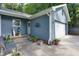 Side patio with bench and potted plants near garage at 3875 Shiloh Trail West Nw, Kennesaw, GA 30144