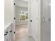 Bathroom with a shower, bedroom, and light flooring at 1695 Thomas St, Decatur, GA 30032
