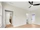 Bedroom with hardwood floors, ceiling fan and access to bathroom and upper hallway at 1695 Thomas St, Decatur, GA 30032