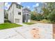 Rear view of two townhouses with attached garages and a shared concrete driveway at 1695 Thomas St, Decatur, GA 30032
