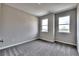 Bright bedroom with gray carpet and neutral walls, featuring two large windows at 252 Eva Way, Cartersville, GA 30121