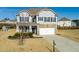 Two-story house with gray siding, stone accents, and a two-car garage at 4675 Dandelion Way, Cumming, GA 30040