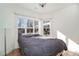 Cozy bedroom with large windows, tile floors, and a gray comforter at 4785 Hubert Martin Rd, Cumming, GA 30028