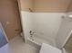 Bathroom with white tiled walls, a bathtub, and neutral flooring at 501 Country Park Se Dr, Smyrna, GA 30080