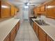 Kitchen with wood cabinets, light countertops, and tile floor at 501 Country Park Se Dr, Smyrna, GA 30080