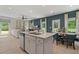Open concept kitchen with island and view of living room at 10 Camellia Dr, Fairburn, GA 30213