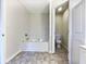 Clean bathroom with bathtub and separate toilet area at 114 Blake Cv, Douglasville, GA 30134