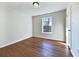 Simple bedroom with wood floors and large window at 114 Blake Cv, Douglasville, GA 30134