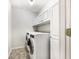 Laundry room with washer, dryer, and ample storage cabinets at 114 Blake Cv, Douglasville, GA 30134