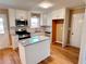 Renovated kitchen featuring white cabinets, granite island, and stainless steel appliances at 2928 Bright Star Rd, Douglasville, GA 30134