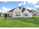 Backyard view of a white two-story house, with a manicured lawn and patio at 2937 Dansby Run, Acworth, GA 30101