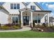 Inviting front porch featuring a cozy seating area, stylish lighting fixtures, and brick accents at 2937 Dansby Run, Acworth, GA 30101