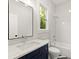 Modern bathroom with white subway tile, navy vanity, and a white bathtub at 1697 Thomas St, Decatur, GA 30032