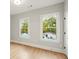 Charming bedroom with hardwood floors and two large windows at 1697 Thomas St, Decatur, GA 30032