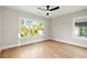 Spacious bedroom with wood floors, ceiling fan, and large windows at 1697 Thomas St, Decatur, GA 30032