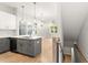 Open concept kitchen and living area with hardwood floors and modern lighting at 1697 Thomas St, Decatur, GA 30032