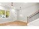Light and airy living room with hardwood floors and a staircase at 1697 Thomas St, Decatur, GA 30032