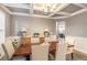 Elegant dining room featuring coffered ceilings, wainscoting, and ample natural light from large windows at 4910 Wagon Trl, Cumming, GA 30028