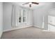 Charming bedroom with carpeted floors, large window, and ceiling fan at 64 Rogers Ne St, Atlanta, GA 30317