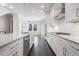 Modern kitchen with white cabinets, quartz countertops and stainless steel appliances at 64 Rogers Ne St, Atlanta, GA 30317