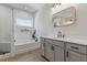 Spa-like bathroom with soaking tub and gray vanity at 711 Bridgeview Dr, Holly Springs, GA 30115