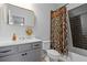 Bathroom with gray vanity, patterned shower curtain and tub at 711 Bridgeview Dr, Holly Springs, GA 30115