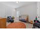 bedroom with a crib and seating area at 711 Bridgeview Dr, Holly Springs, GA 30115
