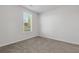 Simple bedroom with carpeted floor and window at 711 Bridgeview Dr, Holly Springs, GA 30115