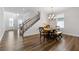 Elegant dining room with hardwood floors and a modern chandelier at 711 Bridgeview Dr, Holly Springs, GA 30115